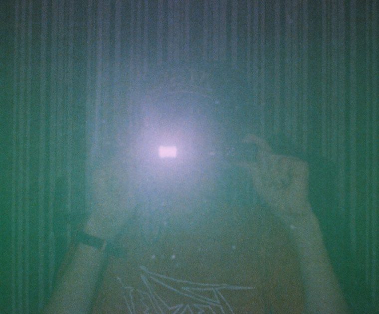 16-YEAR-OLD-ISH ME PERFORMING A MIRROR-SELFIE FROM THE MYSTERIOUS JUNK BOX FILM.